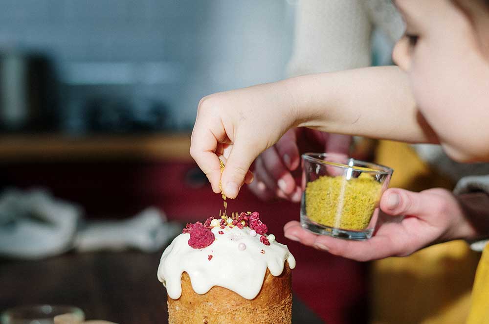 girl in yellow shirt holding brown cake 3992374